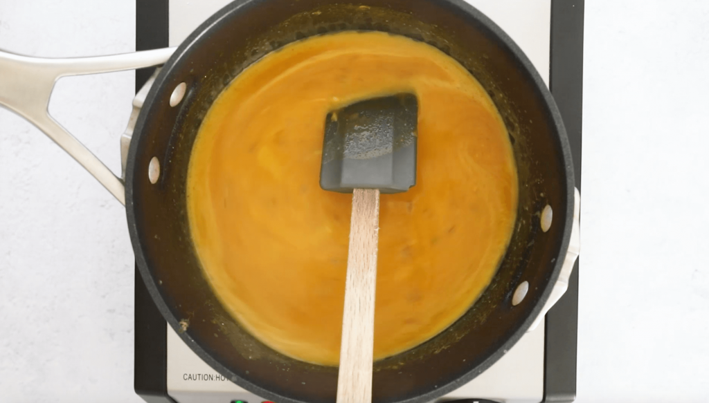curry pumpkin soup cooking in black pot