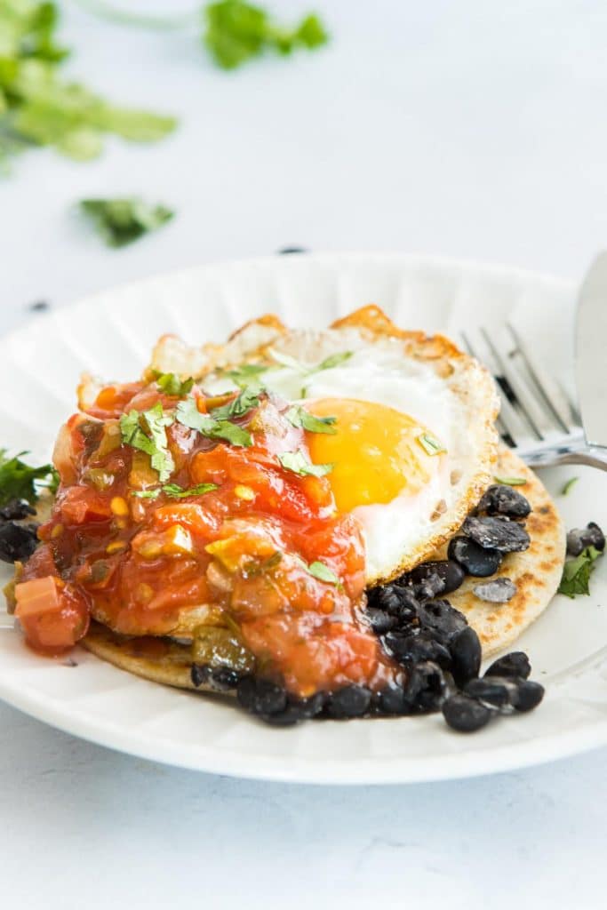 huevos rancheros with tomatoes on top