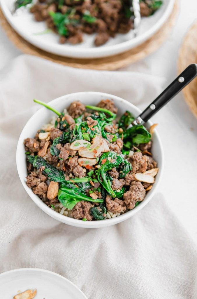 Thai beef and spinach bowl with fried garlic on top