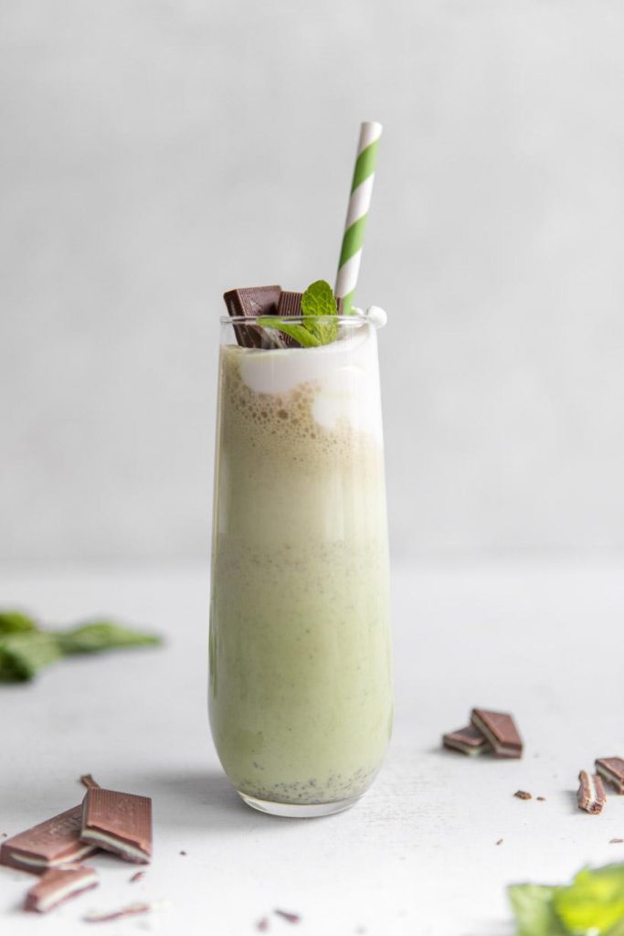homemade shamrock shake in a tall glass with a green straw