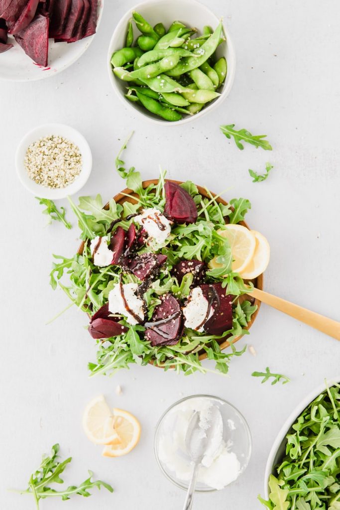 beet and arugula salad and ingredients on a table
