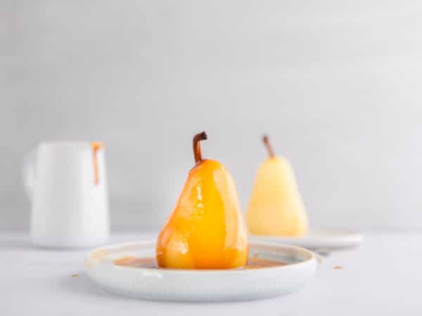 poached pear with caramel in a dish