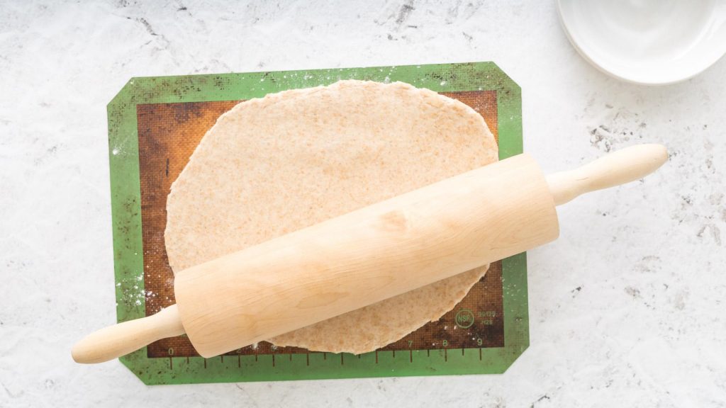 rolling out dough on a table
