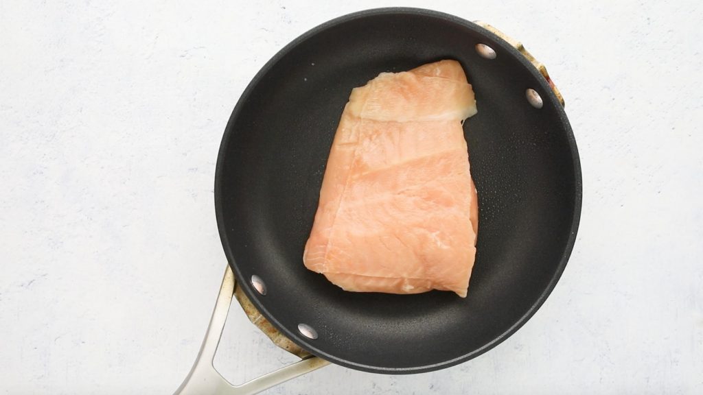 uncooked salmon in pan