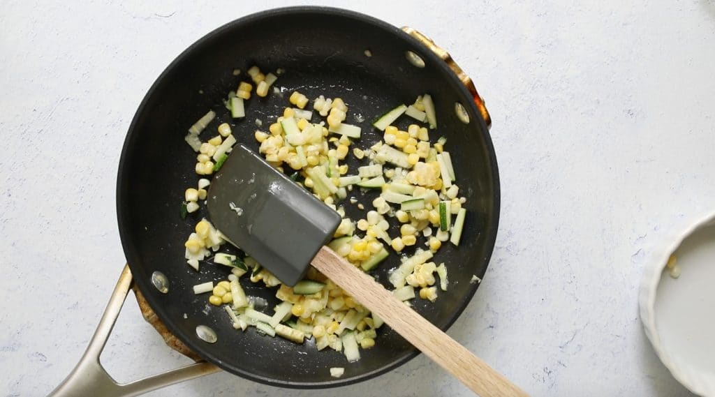zucchini and corn in a fry pan