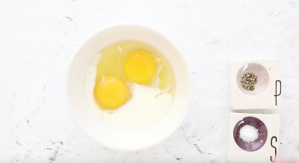 cracked eggs and milk in a bowl