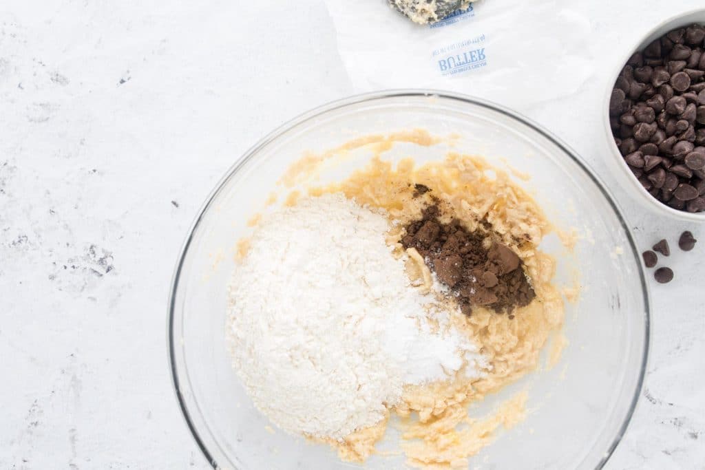 Flour, cocoa powder, and creamed butter and sugar in a glass bowl