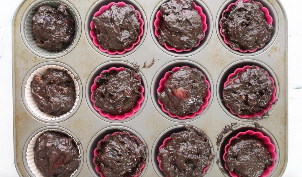 uncooked chocolate blueberry muffins in a muffin tin