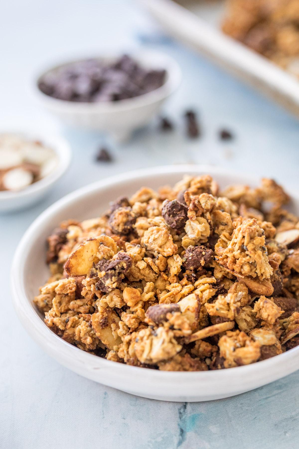 close up of granola with ingredients in background