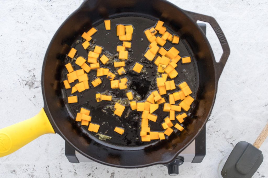 cubed butternut squash in a cast iron skillet