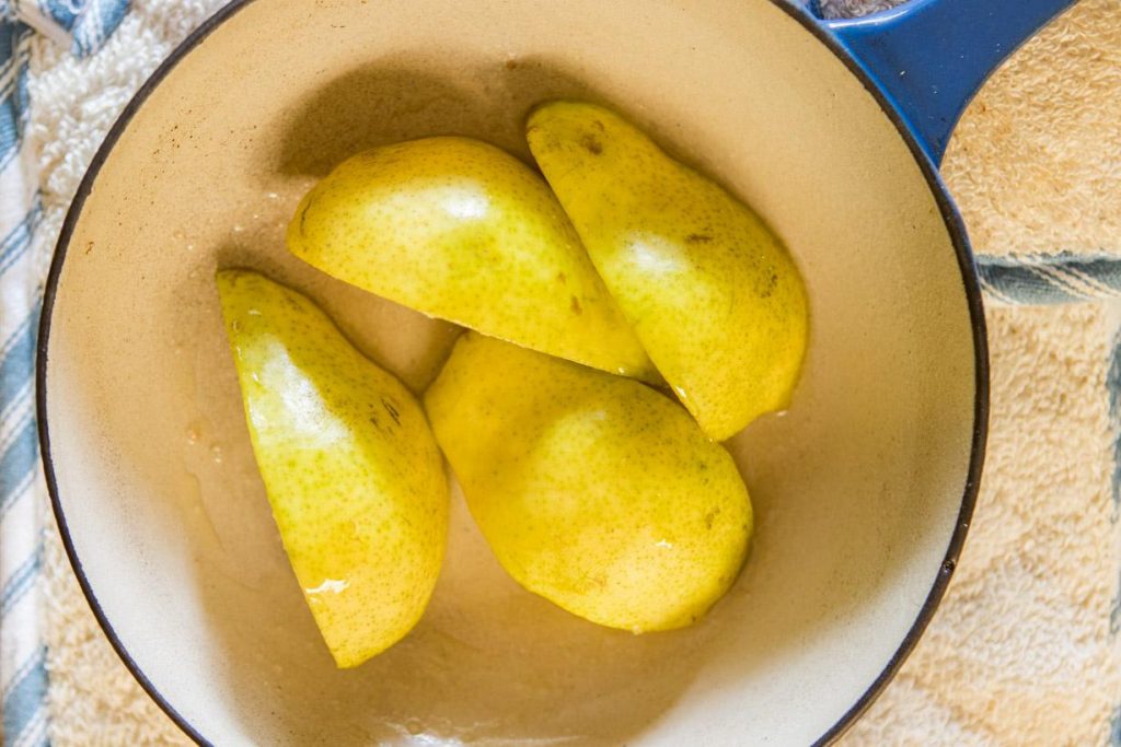 four slice of pear in a small saucepan